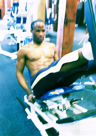 Man using weight machine in gym Stock Photo - Premium Royalty-Free, Code: 696-03399968