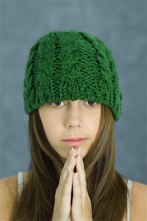 simsearch:400-03929864,k - Teen girl wearing knit hat, hands clasped, portrait Stock Photo - Premium Royalty-Free, Code: 696-03393952