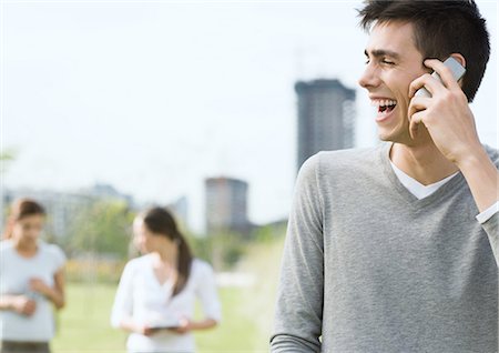 students campus phones - Young man using cell phone in urban park Stock Photo - Premium Royalty-Free, Code: 696-03400175