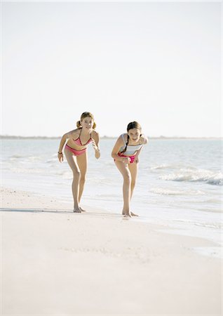 friends competing - Two preteen girls ready to race on beach Stock Photo - Premium Royalty-Free, Code: 696-03400473