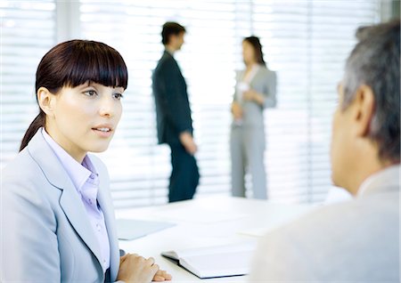 simsearch:632-01155400,k - Business colleagues conversing in office Stock Photo - Premium Royalty-Free, Code: 696-03400487