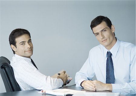 simsearch:632-01155457,k - Business colleagues working together, smiling at camera Stock Photo - Premium Royalty-Free, Code: 696-03400495