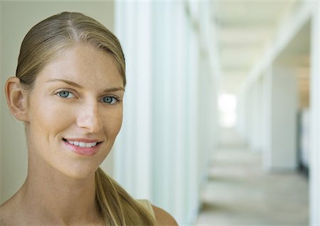 dimpled - Woman standing in corridor, portrait Stock Photo - Premium Royalty-Free, Code: 696-03400598