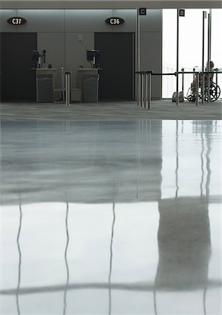 shine floor - Reflection on airport floor, person in wheelchair waiting for assistance in background Stock Photo - Premium Royalty-Free, Code: 696-03400613