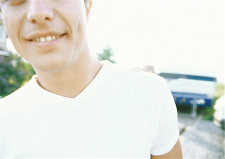 dimpled - Young man, cropped view of head and shoulders Stock Photo - Premium Royalty-Free, Code: 696-03400671