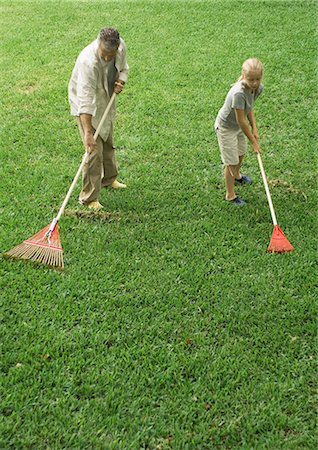 family yard work - Man and daughter raking grass Stock Photo - Premium Royalty-Free, Code: 696-03400693
