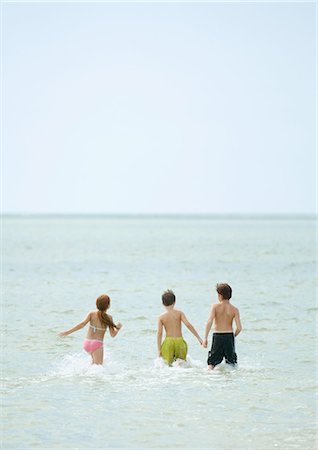 simsearch:632-01156987,k - Children running in surf at beach Stock Photo - Premium Royalty-Free, Code: 696-03400787