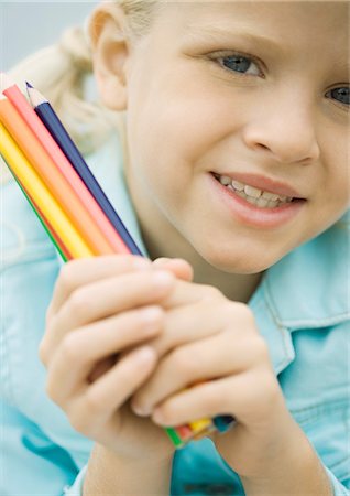 Girl holding colored pencils Stock Photo - Premium Royalty-Free, Code: 696-03400825