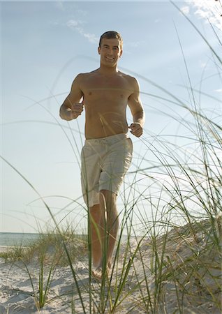 running sand dune - Man running in dunes on beach Stock Photo - Premium Royalty-Free, Code: 696-03400833