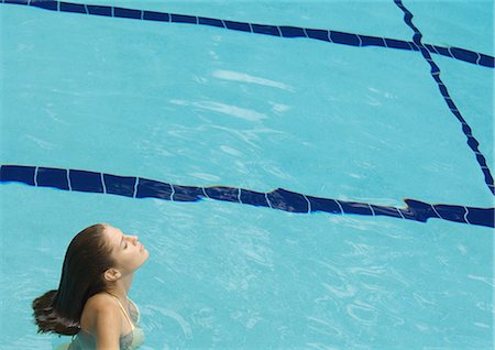 simsearch:632-05604352,k - Woman standing in pool with head back and eyes closed Stock Photo - Premium Royalty-Free, Code: 696-03400864