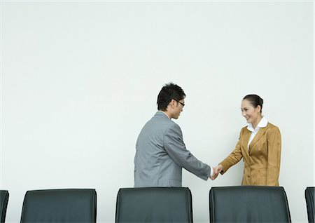 Businessman and businesswoman shaking hands Stock Photo - Premium Royalty-Free, Code: 696-03401095