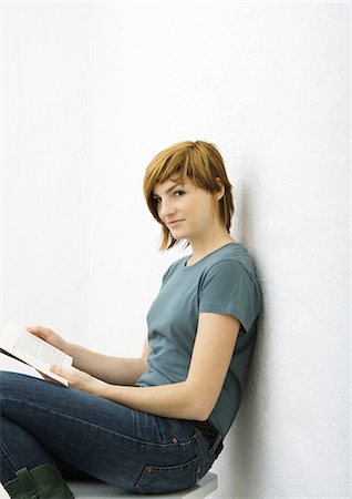 people reading cutout - Young woman sitting with book, portrait Stock Photo - Premium Royalty-Free, Code: 696-03401105