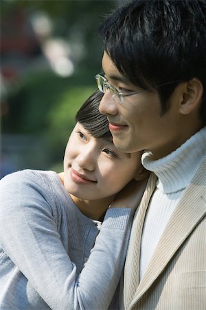 simsearch:632-03779625,k - Young couple, woman leaning head on man's shoulder, both looking away Stock Photo - Premium Royalty-Free, Code: 696-03401135