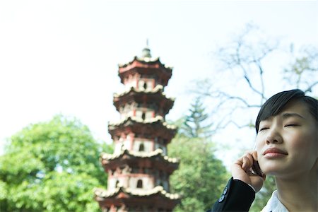 simsearch:696-03394943,k - Woman using cell phone, pagoda in background Stock Photo - Premium Royalty-Free, Code: 696-03401261