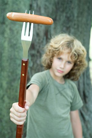simsearch:696-03401434,k - Boy holding hot dog on end of large fork Stock Photo - Premium Royalty-Free, Code: 696-03401435