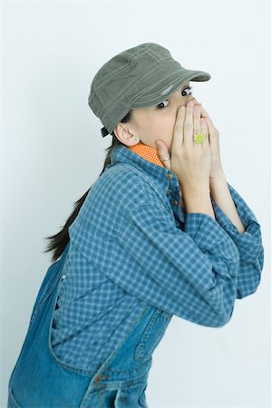 Teenage girl covering lower face with hands, portrait Fotografie stock - Premium Royalty-Free, Codice: 696-03401478