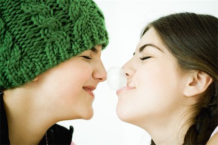 funny pictures people chewing gum - Two young female friends, one blowing bubble with gum, touching friend's nose Stock Photo - Premium Royalty-Free, Code: 696-03401549