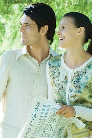 profile portrait man aspirational - Couple, woman holding newspaper, both looking out of frame Stock Photo - Premium Royalty-Free, Code: 696-03401633