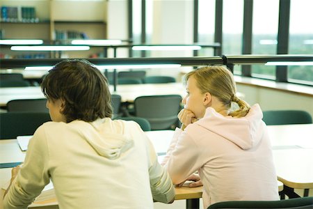ponytail closeup back - Two college students sitting at table in library, rear view Stock Photo - Premium Royalty-Free, Code: 696-03401656