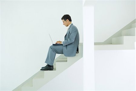 simsearch:633-01713826,k - Man sitting on stairs, using laptop Stock Photo - Premium Royalty-Free, Code: 696-03401681