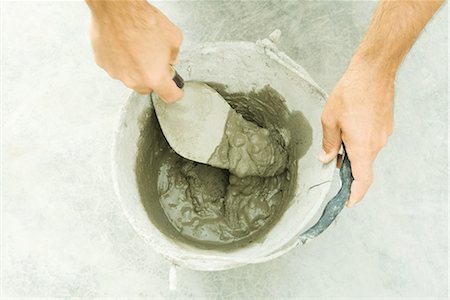 person with trowel - Man preparing putty, cropped view of hands Stock Photo - Premium Royalty-Free, Code: 696-03401871