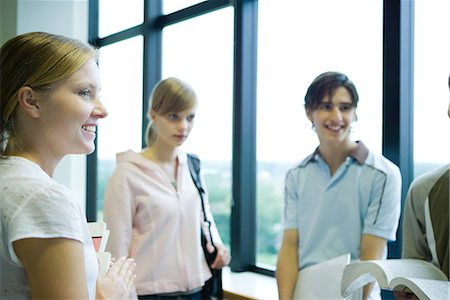 simsearch:632-01156768,k - Group of students standing by window, smiling, waist up Stock Photo - Premium Royalty-Free, Code: 696-03401902