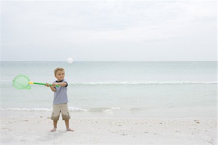 simsearch:695-03377206,k - Little boy standing on beach, catching ball with net, full length Stock Photo - Premium Royalty-Free, Code: 696-03402029