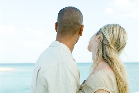 simsearch:632-03779401,k - Couple looking at ocean view together, rear view Stock Photo - Premium Royalty-Free, Code: 696-03402108