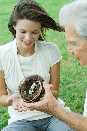 simsearch:695-03377910,k - Grandfather and teen granddaughter looking at bird's nest together, cropped view Fotografie stock - Premium Royalty-Free, Codice: 696-03402222