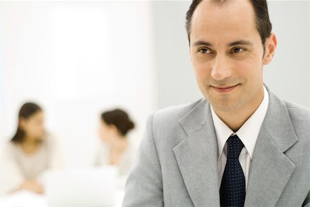 simsearch:695-03378508,k - Businessman looking away, smiling, close-up Stock Photo - Premium Royalty-Free, Code: 696-03402306