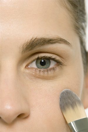 perfect makeup - Woman applying make-up to cheek, cropped view of face Stock Photo - Premium Royalty-Free, Code: 696-03402339