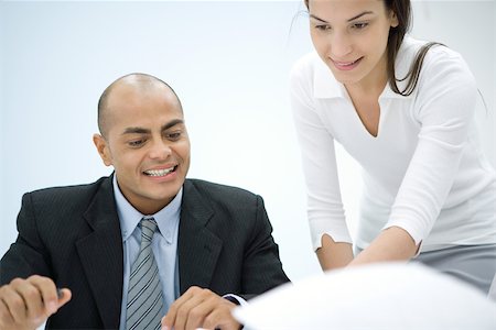 simsearch:632-01155400,k - Two business associates working together, smiling Stock Photo - Premium Royalty-Free, Code: 696-03402461