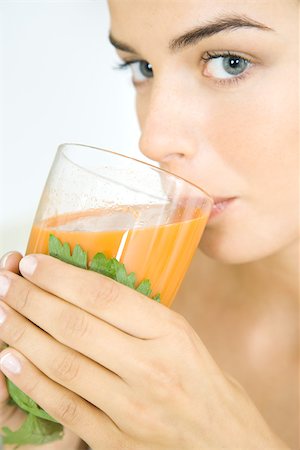 simsearch:695-03378760,k - Young woman drinking a glass of fresh vegetable juice Foto de stock - Sin royalties Premium, Código: 696-03402511