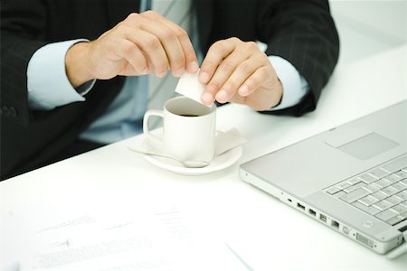 Professional man preparing coffee at desk, cropped view Stock Photo - Premium Royalty-Free, Code: 696-03402734