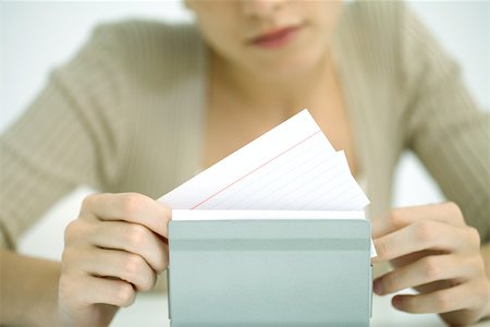 schedario alfabetico - Woman flipping through card file, cropped view Fotografie stock - Premium Royalty-Free, Codice: 696-03402739