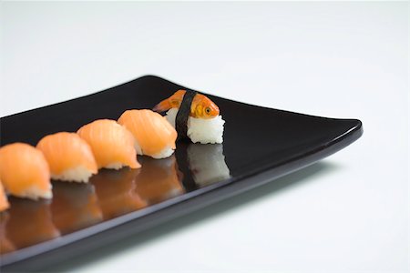 simsearch:633-02345764,k - Goldfish prepared as nigiri sushi, placed with row of salmon nigiri sushi Stock Photo - Premium Royalty-Free, Code: 696-03402751