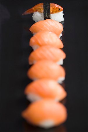 Goldfish prepared as nigiri sushi, placed as end piece of row of salmon nigiri sushi Stock Photo - Premium Royalty-Free, Code: 696-03402765