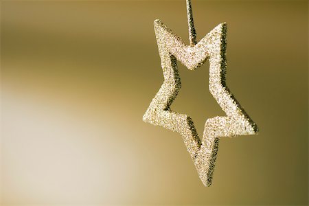Golden star shaped Christmas tree ornament, upside down Stock Photo - Premium Royalty-Free, Code: 696-03402815