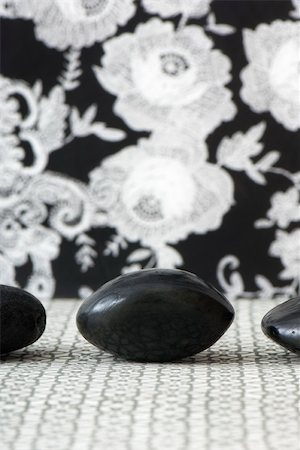 Three polished pebbles in row against patterned background, cropped Stock Photo - Premium Royalty-Free, Code: 696-03402832