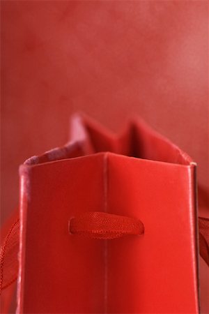 ribbon detail - Top of red gift bag, detail Stock Photo - Premium Royalty-Free, Code: 696-03402833