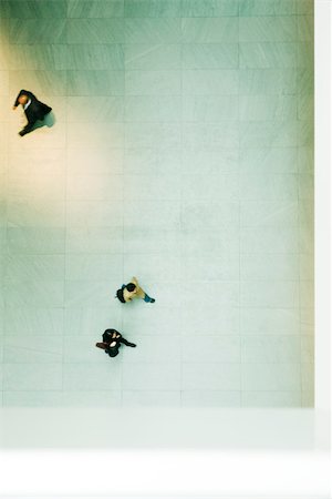 rushing - Pedestrians walking across floor of large lobby, viewed from directly overhead Stock Photo - Premium Royalty-Free, Code: 696-03402935