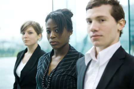 depending - Three business associates standing side by side looking at camera Stock Photo - Premium Royalty-Free, Code: 696-03403014