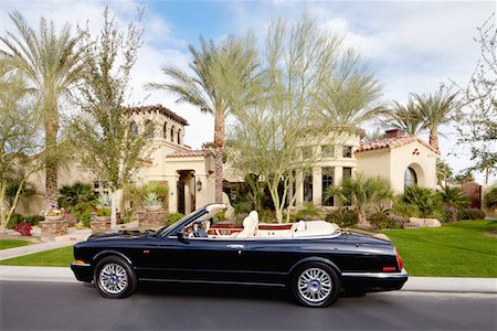 rich lifestyle car - Black open roof car parked in front of mansion house Stock Photo - Premium Royalty-Free, Code: 693-05552678