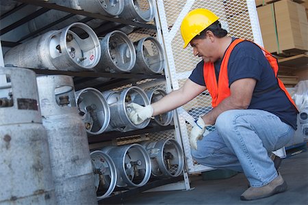 Worker checking the pressure of cylinder Foto de stock - Sin royalties Premium, Código: 693-05552707