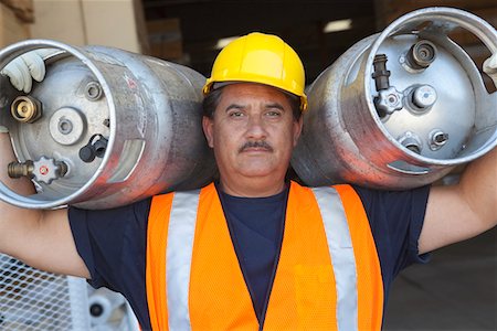 Portrait of a middle-aged man carrying cylinder Stock Photo - Premium Royalty-Free, Code: 693-05552718