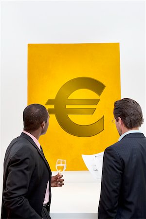 simsearch:693-05552781,k - Male executive looking at Euro sign over white background Stock Photo - Premium Royalty-Free, Code: 693-05552781