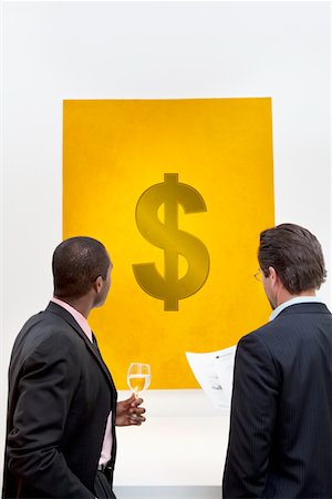 dollar sign - Male executive looking at Dollar sign over white background Foto de stock - Sin royalties Premium, Código: 693-05552783