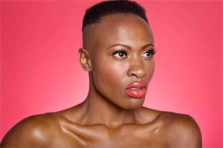 eye wear - Close up of serious African American woman over colored background Stock Photo - Premium Royalty-Free, Code: 693-05552898