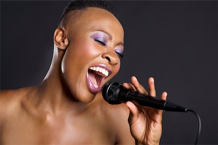 Close-up of African American woman singing Foto de stock - Sin royalties Premium, Código: 693-05552919