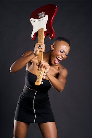 rebel woman - African American woman about to break guitar Stock Photo - Premium Royalty-Free, Code: 693-05552922